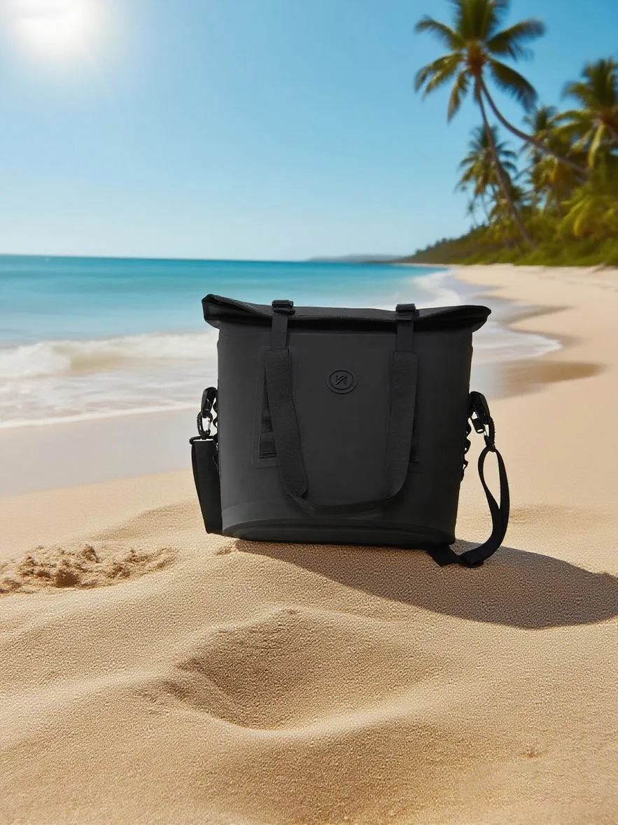 Black roll-top dry bag closed on wet sand