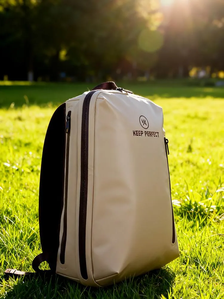Grey waterproof backpack resting on a mossy rock