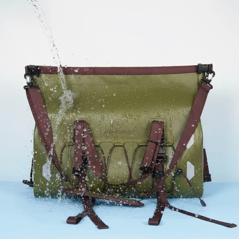 Olive dry duffel bag resting on the ground