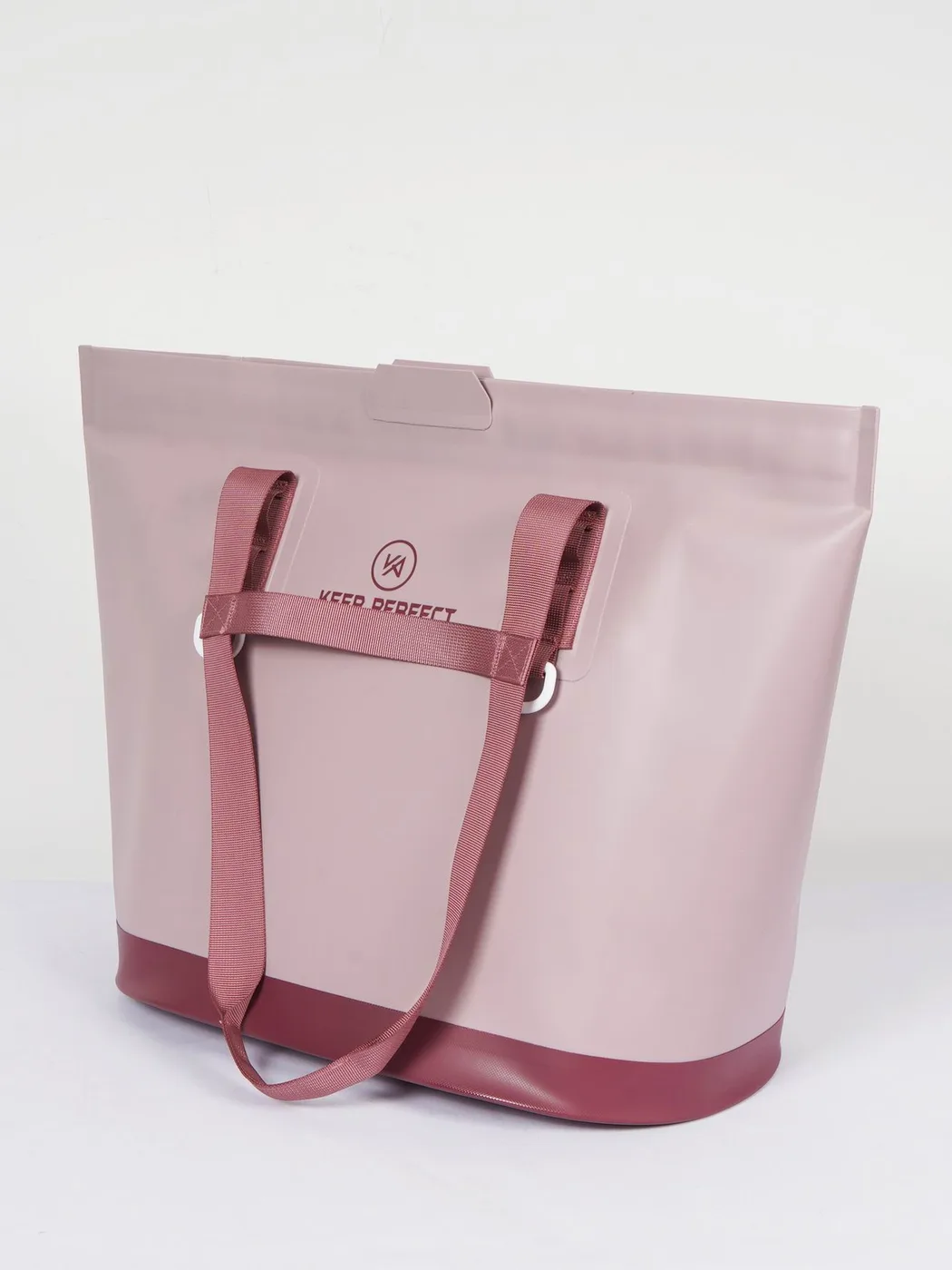 Pink roll-top dry bag wedged between rocks